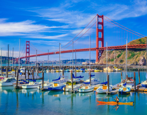 calm harbor with sail boats and the golden gate bridge